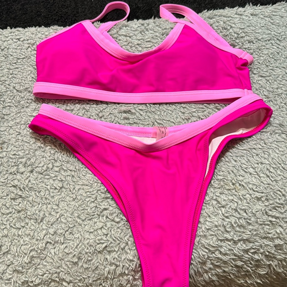 Never worn. Too big. Pink swim suit.